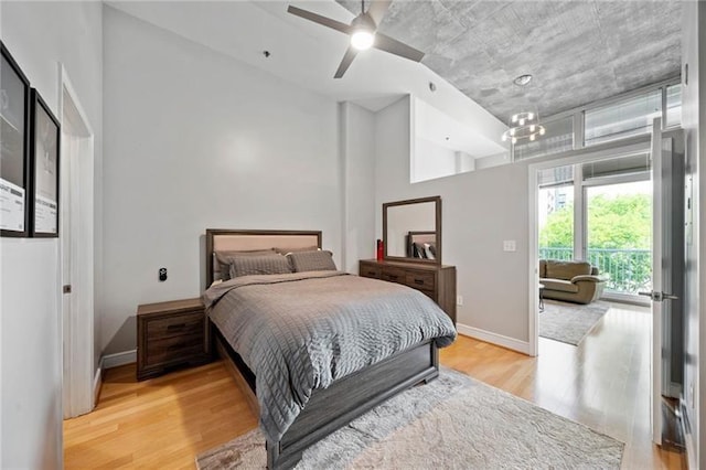 44 Peachtree Pl NW Unit 528, Atlanta, GA 30309 - bedroom featuring a ceiling fan, baseboards, a towering ceiling, and light wood-style floors