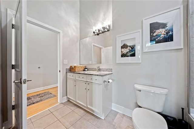 44 Peachtree Pl NW Unit 528, Atlanta, GA 30309 - full bathroom with vanity, toilet, tile patterned flooring, and baseboards