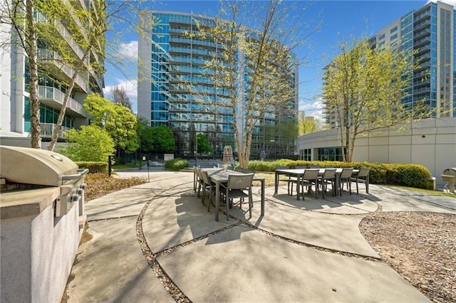 44 Peachtree Pl NW Unit 528, Atlanta, GA 30309 - view of home's community featuring outdoor dining space and a patio