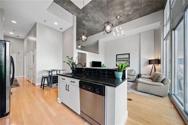 44 Peachtree Pl NW Unit 528, Atlanta, GA 30309 - kitchen with dark countertops, open floor plan, stainless steel appliances, and a sink