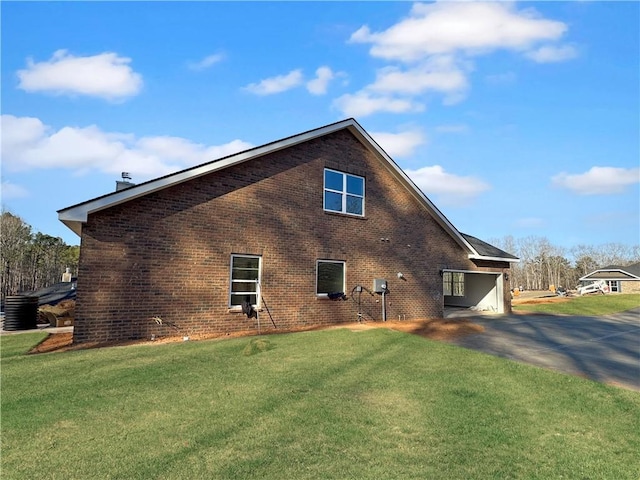 view of side of property with a lawn