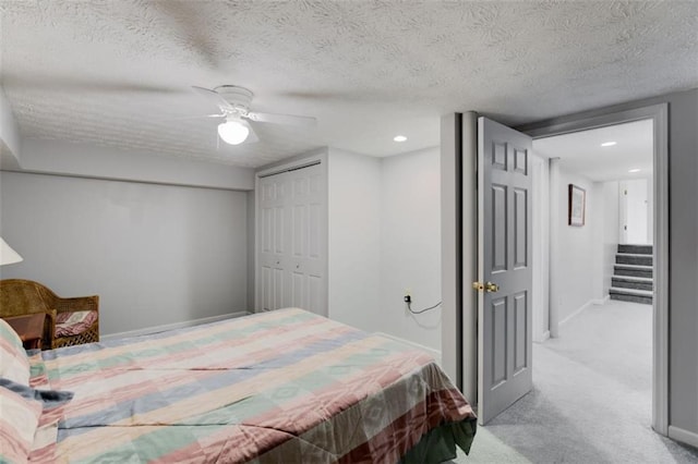 3359 Villa Ln, Douglasville, GA 30135 - carpeted bedroom featuring a ceiling fan, a textured ceiling, a closet, and recessed lighting