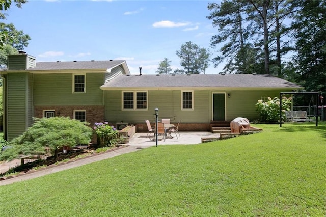 3359 Villa Ln, Douglasville, GA 30135 - back of property with a chimney, a patio, a lawn, and brick siding