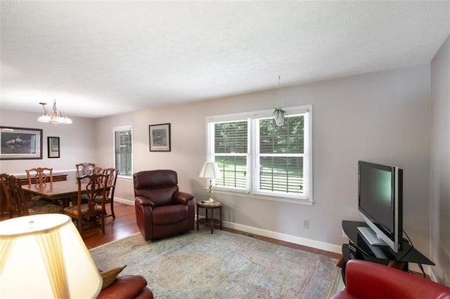 3359 Villa Ln, Douglasville, GA 30135 - living area with a chandelier, a textured ceiling, and wood finished floors
