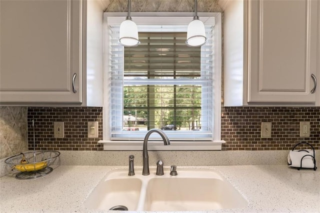 3359 Villa Ln, Douglasville, GA 30135 - kitchen with tasteful backsplash, hanging light fixtures, and light stone countertops