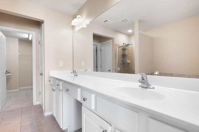 full bathroom with double vanity, visible vents, a sink, and tile patterned floors