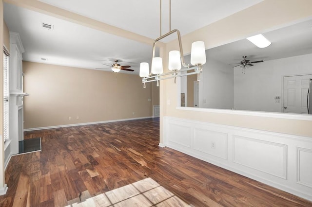 interior space featuring dark wood-style floors, visible vents, baseboards, and a ceiling fan