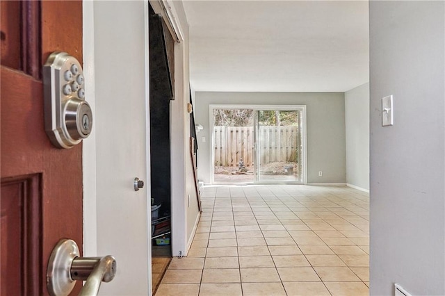 hall featuring light tile patterned floors