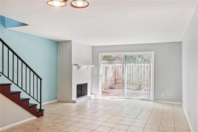 unfurnished living room featuring light tile patterned floors and a fireplace