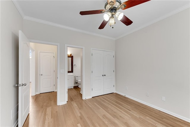 unfurnished bedroom with crown molding, light wood-style floors, baseboards, and connected bathroom