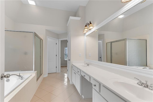 full bath featuring tile patterned floors, a stall shower, a garden tub, and a sink