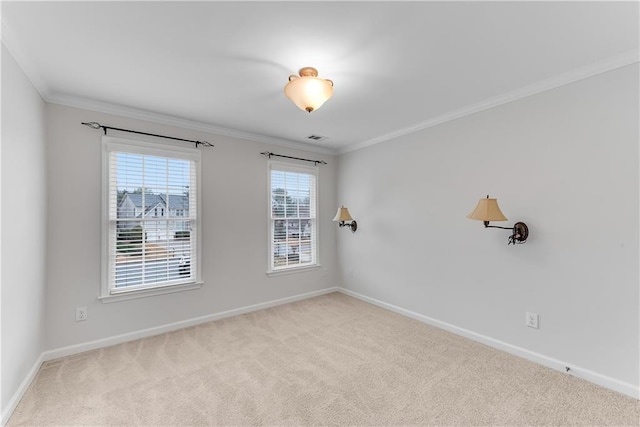 carpeted empty room with visible vents, baseboards, and ornamental molding