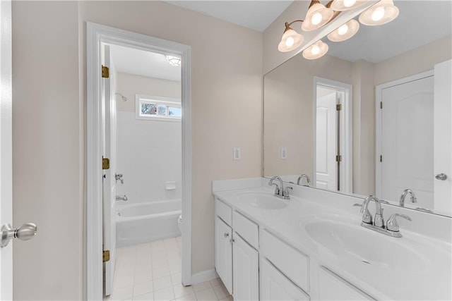 full bath with a sink, toilet, double vanity, and tile patterned floors