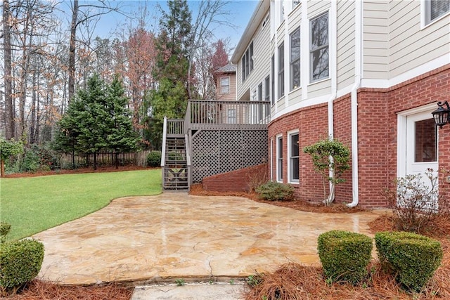 view of patio featuring stairway, a deck, and fence