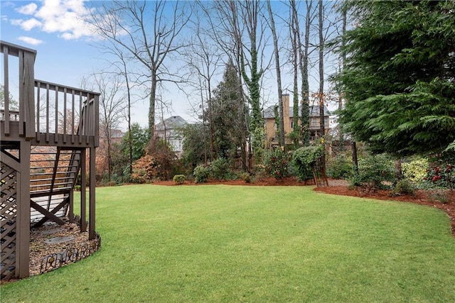 view of yard with a deck and stairs