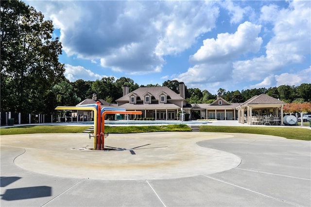 surrounding community with a gazebo and a yard