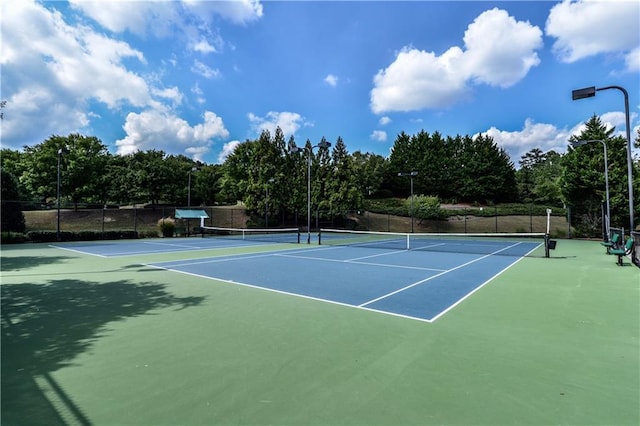 view of sport court featuring fence