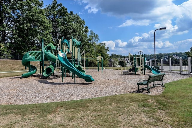 communal playground with a yard and fence