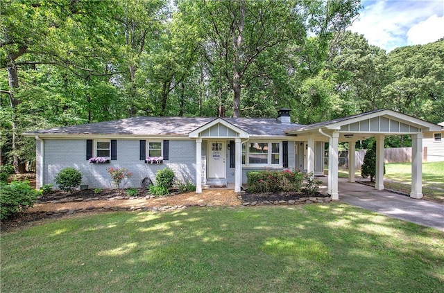 single story home featuring brick siding, aphalt driveway, a chimney, and a front lawn