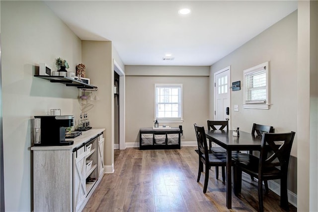 dining area with recessed lighting, baseboards, visible vents, and wood finished floors