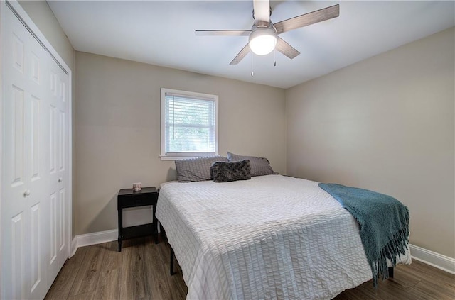 bedroom featuring a closet, a ceiling fan, baseboards, and wood finished floors