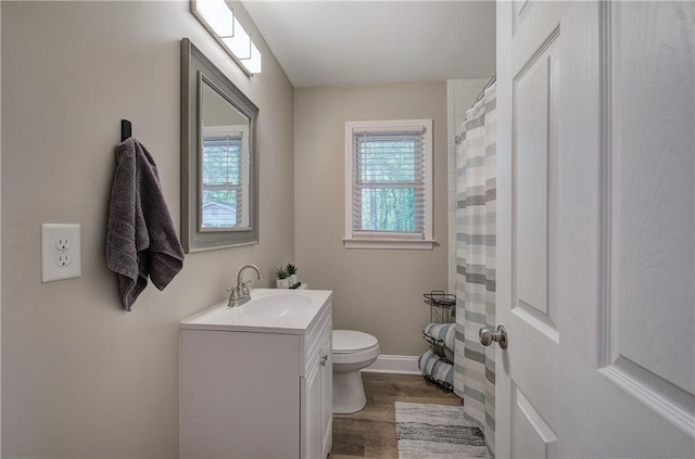 bathroom featuring vanity, toilet, wood finished floors, and a shower with shower curtain