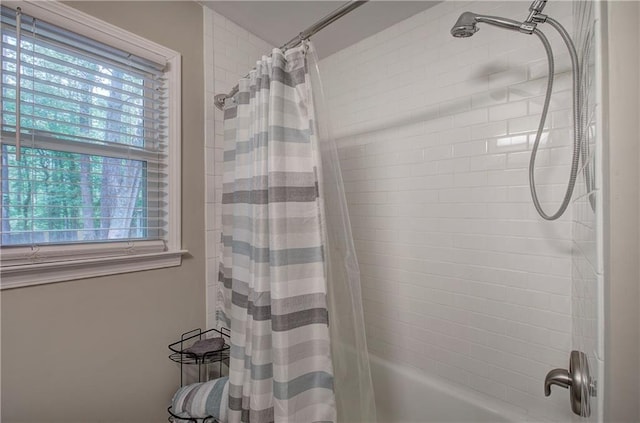 bathroom featuring shower / bath combo and a healthy amount of sunlight