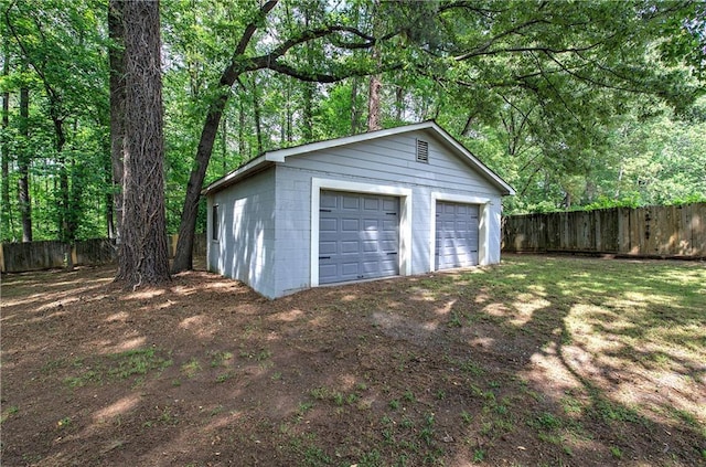 detached garage featuring fence