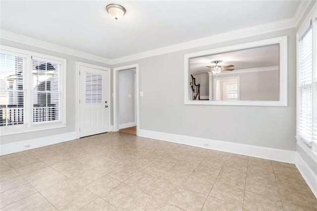 empty room featuring ceiling fan and crown molding