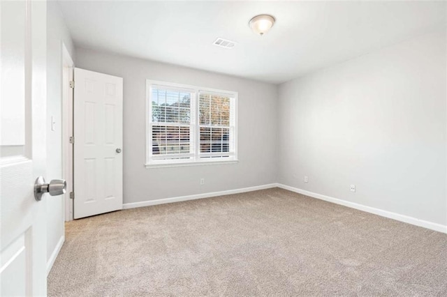 empty room featuring light carpet