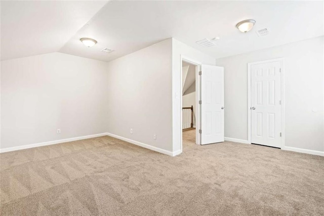 interior space with carpet and vaulted ceiling