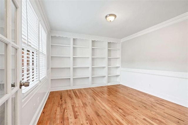 unfurnished room featuring hardwood / wood-style floors and ornamental molding