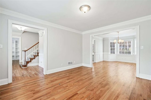 spare room featuring light hardwood / wood-style floors and crown molding