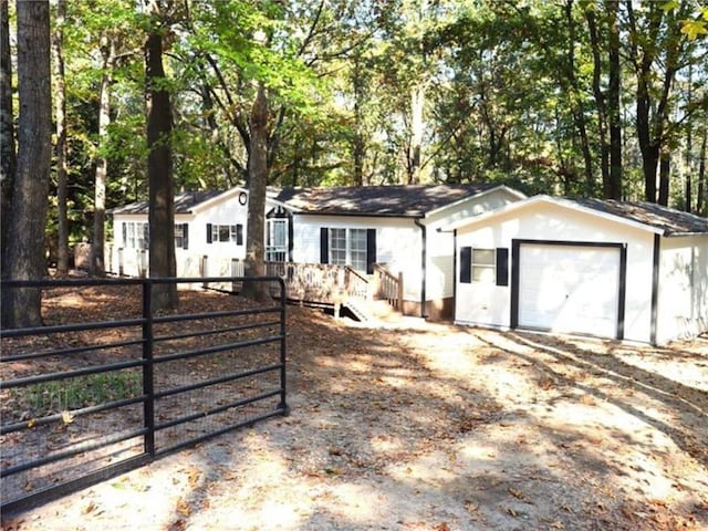 576 Nichols Rd, Pendergrass, GA 30567 - single story home featuring fence, a gate, dirt driveway, and a garage