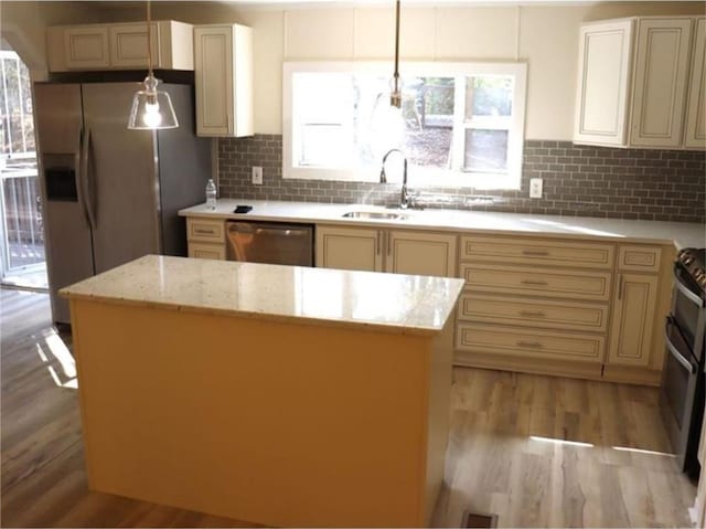 576 Nichols Rd, Pendergrass, GA 30567 - kitchen with stainless steel appliances, a sink, cream cabinetry, and light wood-type flooring