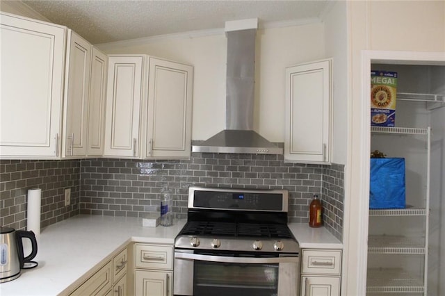 576 Nichols Rd, Pendergrass, GA 30567 - kitchen featuring stainless steel gas range oven, wall chimney exhaust hood, crown molding, light countertops, and backsplash