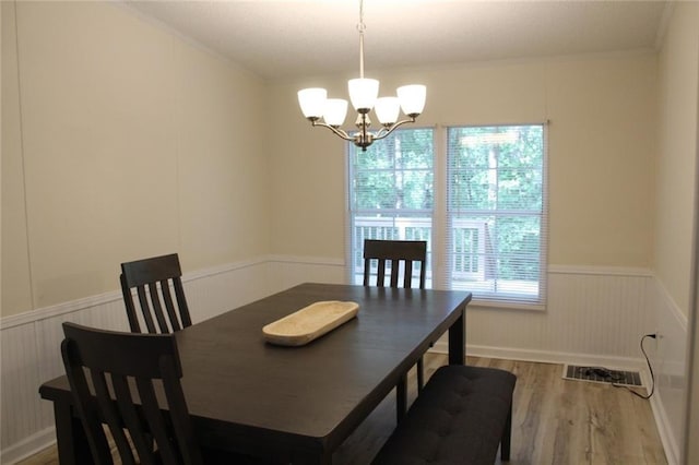 576 Nichols Rd, Pendergrass, GA 30567 - dining area with a wainscoted wall, a chandelier, wood finished floors, and crown molding