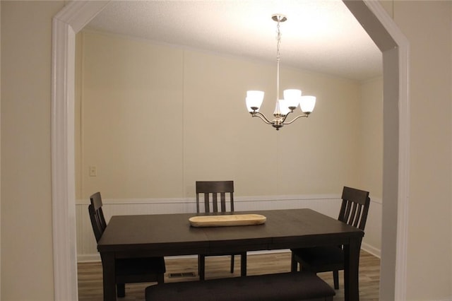 576 Nichols Rd, Pendergrass, GA 30567 - dining room with a chandelier, wood finished floors, wainscoting, and arched walkways