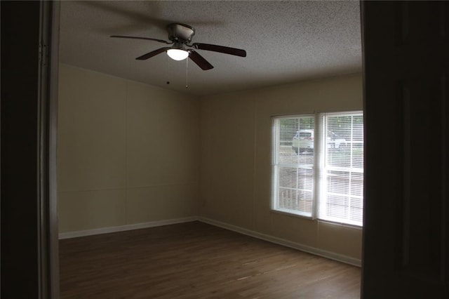 576 Nichols Rd, Pendergrass, GA 30567 - empty room featuring wood finished floors, plenty of natural light, ceiling fan, a textured ceiling, and baseboards