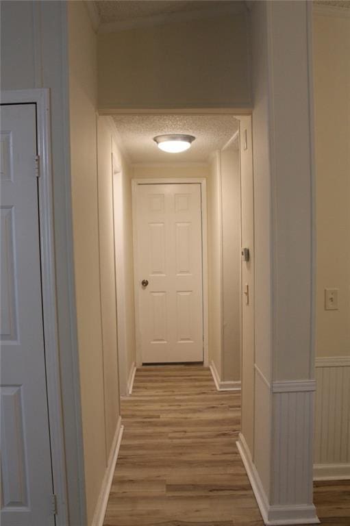 576 Nichols Rd, Pendergrass, GA 30567 - hallway with light wood-style flooring, a textured ceiling, and ornamental molding