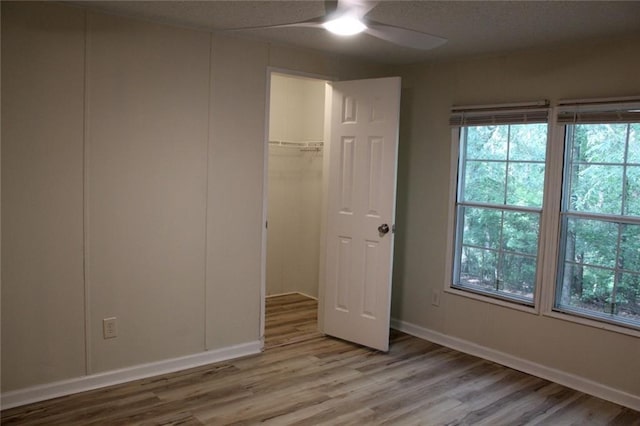 576 Nichols Rd, Pendergrass, GA 30567 - unfurnished bedroom with wood finished floors, multiple windows, and baseboards