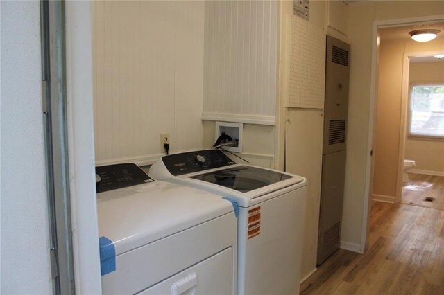 576 Nichols Rd, Pendergrass, GA 30567 - laundry room featuring separate washer and dryer, light wood-style floors, a heating unit, and baseboards