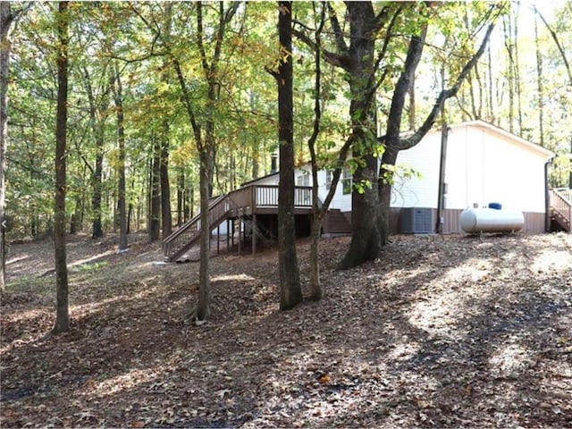 576 Nichols Rd, Pendergrass, GA 30567 - view of side of property with stairs, a wooden deck, and a view of trees