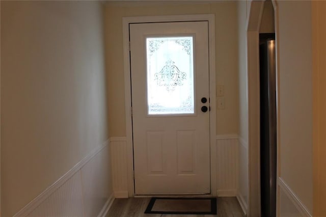 576 Nichols Rd, Pendergrass, GA 30567 - entryway with wainscoting, a decorative wall, light wood-type flooring, and arched walkways