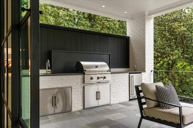 view of patio / terrace with an outdoor kitchen, sink, and area for grilling