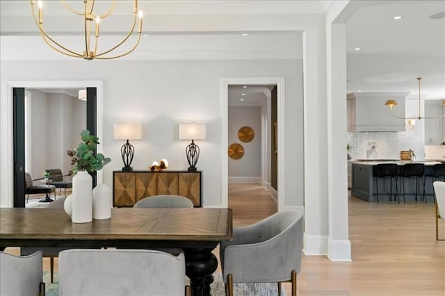 dining room with a chandelier and light wood-type flooring