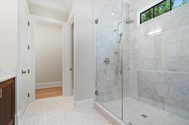 bathroom with walk in shower and vanity