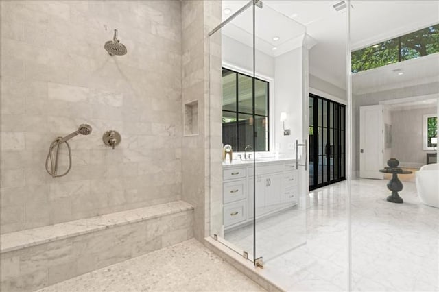 bathroom with vanity and tiled shower