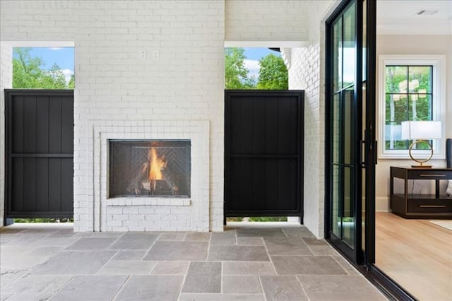 interior space featuring a brick fireplace and a patio area