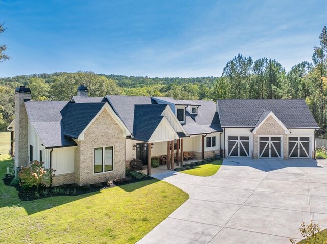 441 Pumpkinvine Rd, Acworth, GA 30101 - modern farmhouse style home featuring board and batten siding, a front yard, roof with shingles, a chimney, and an attached garage